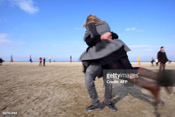Couples re-enact the kiss scene of French film director Claude Lelouch's 1966 movie, "Une Homme et Une Femme" film filmed on Deauville's beach...