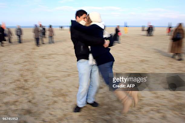 Couples re-enacts the kiss scene of French film director Claude Lelouch's 1966 movie, "Une Homme et Une Femme" film filmed on Deauville's beach...
