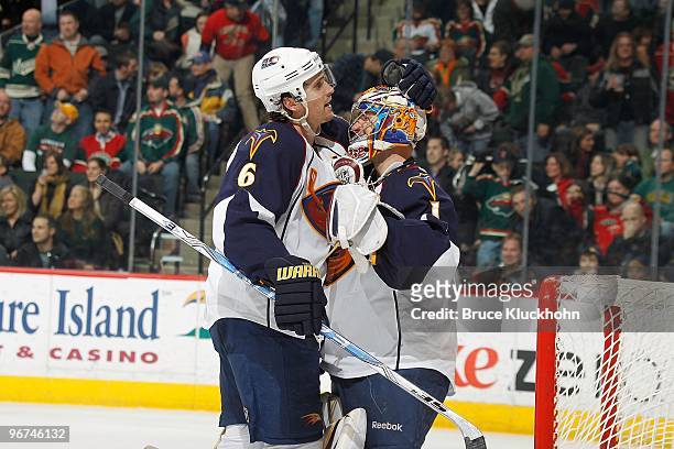 Ron Hainsey and goalie Johan Hedberg of the Atlanta Thrashers celebrate after defeating the Minnesota Wild at the Xcel Energy Center on February 12,...
