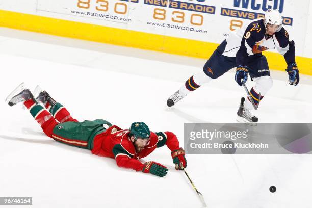 Brent Burns of the Minnesota Wild falls while skating to puck against Evander Kane of the Atlanta Thrashers during the game at the Xcel Energy Center...