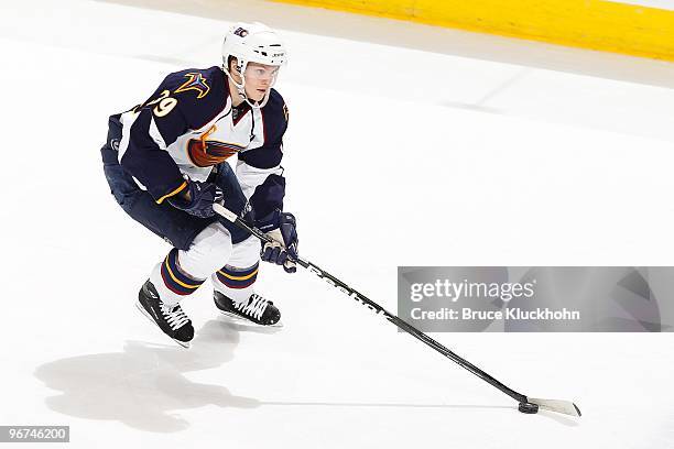 Tobias Enstrom of the Atlanta Thrashers skates with the puck against the Minnesota Wild during the game at the Xcel Energy Center on February 12,...