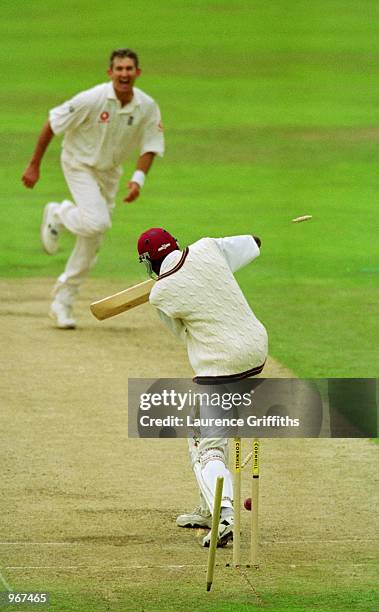 Andrew Caddick of England takes the wicket of Curtly Ambrose of the West Indies during the Fourth Test match played at Headingley, in Leeds, England....