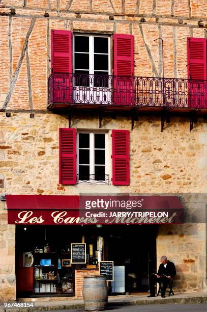 Facade of typical house located Place Edmond Michelet, wineshop Les Caves Michelet, Figeac, Lot, Midi-Pyrénées, France.