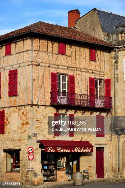 Facade of typical house located Place Edmond Michelet, wineshop Les Caves Michelet, Figeac, Lot, Midi-Pyrénées, France.