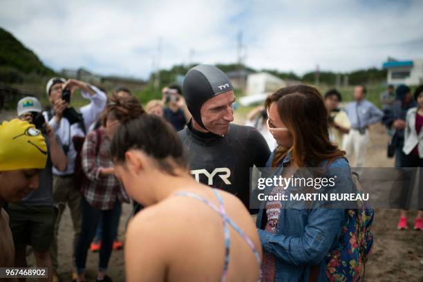 French marathon swimmer Benoit "Ben" Lecomte prepares himself surrounded by his son Max , his wife Trinh and his daughter Ana , in Choshi, Chiba...