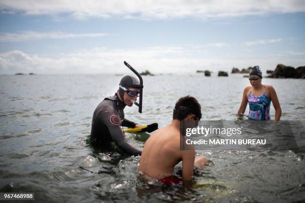 French marathon swimmer Benoit "Ben" Lecomte , takes the start of his attempt of swimming across the Pacific Ocean in Choshi, Chiba prefecture on...