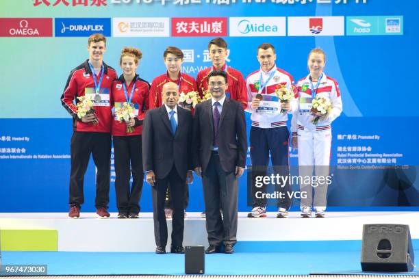 Si Yajie of China and Lian Junjie of China stand on the podium after winning the Mixed 10m Synchro Platform final on the opening day of the 21st FINA...