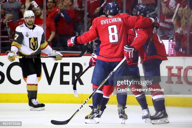 Brett Connolly of the Washington Capitals is congratulated by his teammates after scoring a third-periof goal as Shea Theodore of the Vegas Golden...