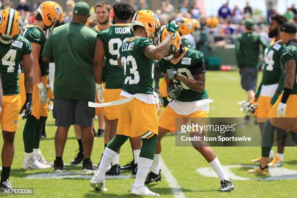Green Bay Packers cornerback Jaire Alexander tries to avoid a Green Bay Packers cornerback Kevin King jab during Green Bay Packers Organized Team...