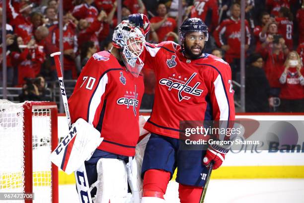 Braden Holtby and Devante Smith-Pelly of the Washington Capitals celebrate their team's 6-2 win over the Vegas Golden Knights in Game Four of the...