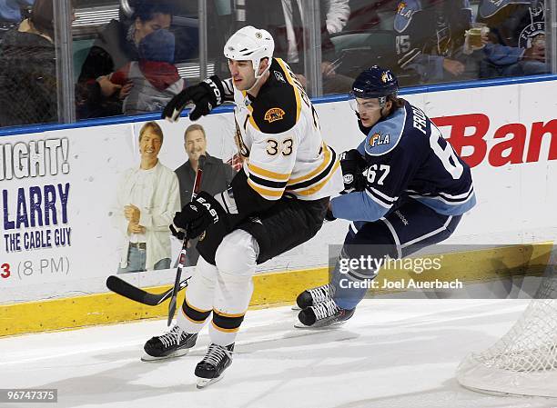 Michael Frolik of the Florida Panthers Zdeno Chara of the Boston Bruins into the corner after the puck on February 13, 2010 at the BankAtlantic...