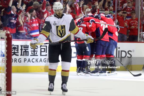 Brett Connolly of the Washington Capitals is congratulated by his teammates after scoring a third-periof goal as Shea Theodore of the Vegas Golden...