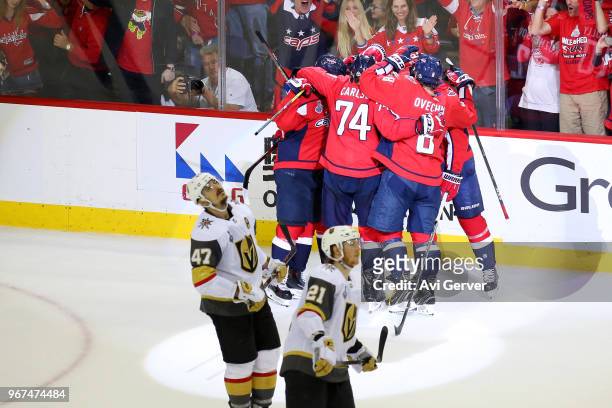 Brett Connolly of the Washington Capitals is congratulated by his teammates after scoring a third-periof goal as Luca Sbisa and Cody Eakin of the...