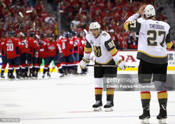 Tomas Nosek and Shea Theodore of the Vegas Golden Knights react to their loss as the Washington Capitals celebrate thier 6-2 win in Game Four of the...