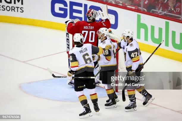 Reilly Smith of the Vegas Golden Knights is congratulated by his teammates Colin Miller and Luca Sbisa after scoring a third-period goal against the...