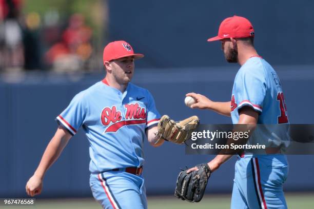 Mississippi Rebels pitcher Connor Green gives the ball over to Mississippi Rebels pitcher Colin Coates during the Tennessee Tech Golden Eagles versus...