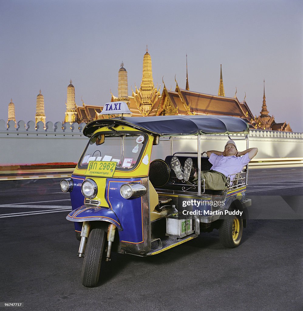 Driver sleeping in Tuk Tuk