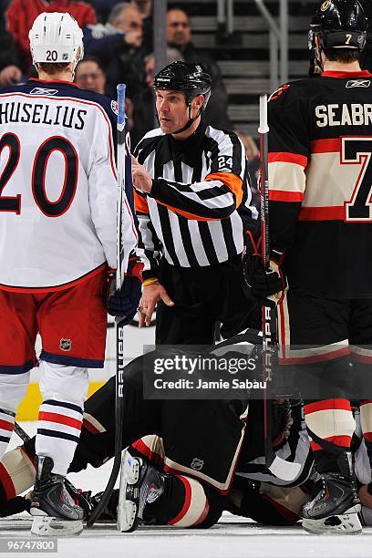 Referee Stephen Walkom attempts to keep the peace between the Columbus Blue Jackets and the Chicago Blackhawks on February 14, 2010 at Nationwide...