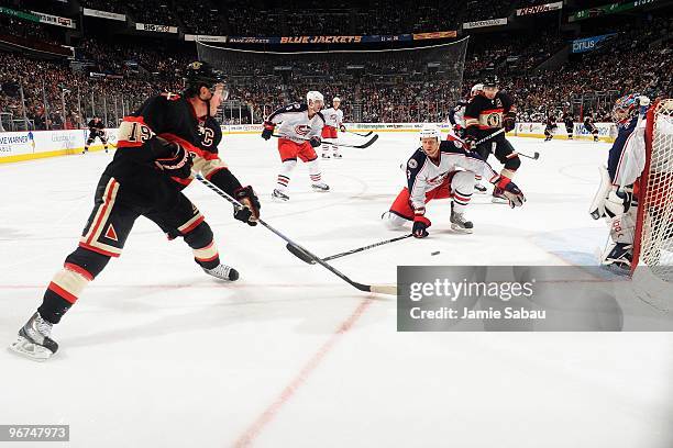 Forward Jonathan Toews of the Chicago Blackhawks skates with the puck against Marc Methot of the Columbus Blue Jackets on February 14, 2010 at...