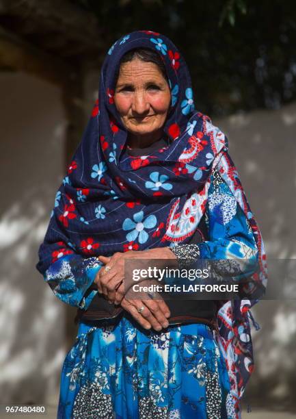 Afghan woman in her traditional pamiri house courtyard, Badakhshan province, Qazi deh, Afghanistan.