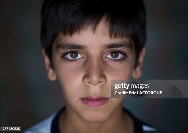 An afghan refugee boy with green eyes, isfahan province, kashan, Iran on October 21, 2015 in Kashan, Iran.