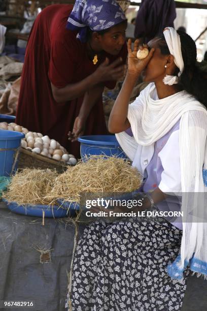 One Ethiopian woman is bargaining with another woman selling eggs at the Bahir Dar market near Lake Tana on April 23, 2009 in Bahir Dar, Ethiopia.