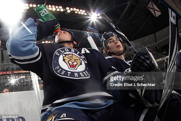 Stephen Weiss of the Florida Panthers cools off and teammate Michael Frolik watches the play from the bench against the Boston Bruins at the...