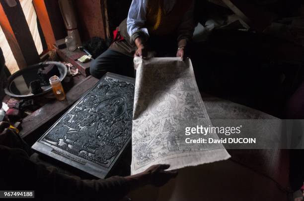 Printed picture and carved wood block, at Dege printing house in Kham region in oriental Tibet Szechuan province in China, on August 18, 2010.