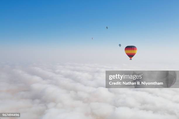 dubai hot air balloons in fog - high up stock pictures, royalty-free photos & images
