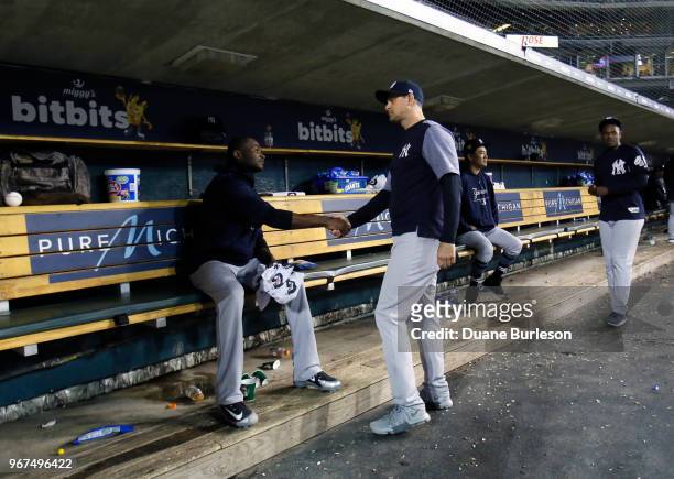 Manager Aaron Boone of the New York Yankees shakes hands with starting pitcher Domingo German of the New York Yankees after he was pulled from game...