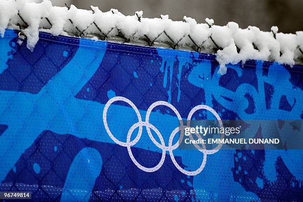 The Olympic logo is seen as rain showers replace snow flurries on February 16, 2010 at the Whistler Creekside Alpine skiing venue of the Vancouver...