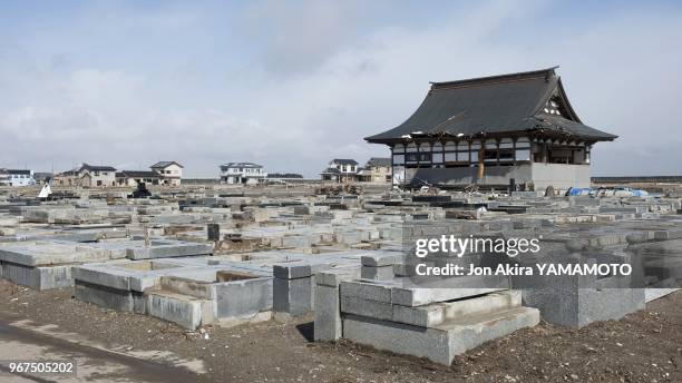 Defiled grave sites in front of a damged Buddhist temple in the Yuriage area on March 13, 2012 in Natori, Japan.