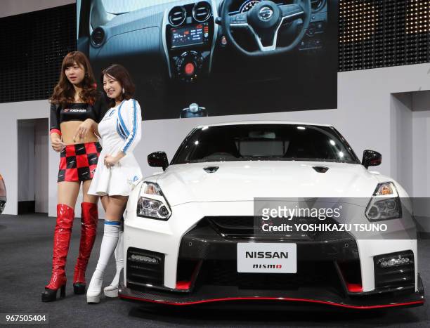 Models display Nissan Motor's GT-R tuned by Nismo at the Tokyo Auto Salon 2017 in Chiba, suburban Tokyo on Friday, January 13, 2017.