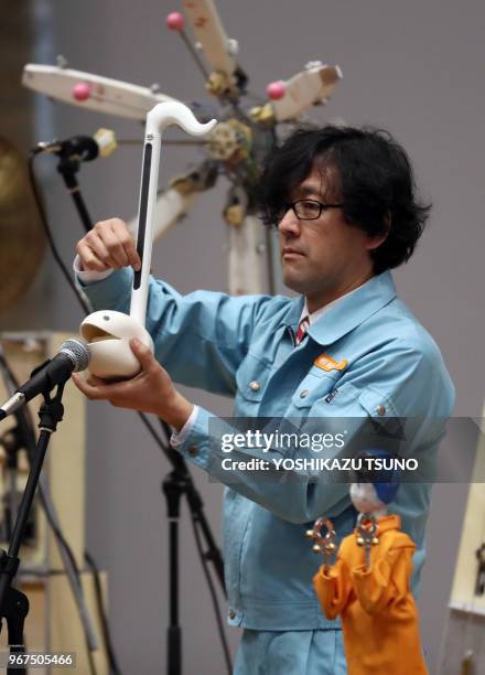 Member of Japan's art unit Maywa Denki, Novmichi Tosa plays music with his unique instrument gadget Otamatone for their live performance at the...