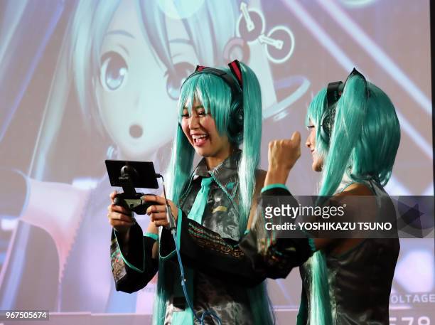 Models in costume of Hatsune Miku plays videogame with Sony's Xperia smartphone at the annual Tokyo Game Show in Chiba, suburban Tokyo on Thursday,...
