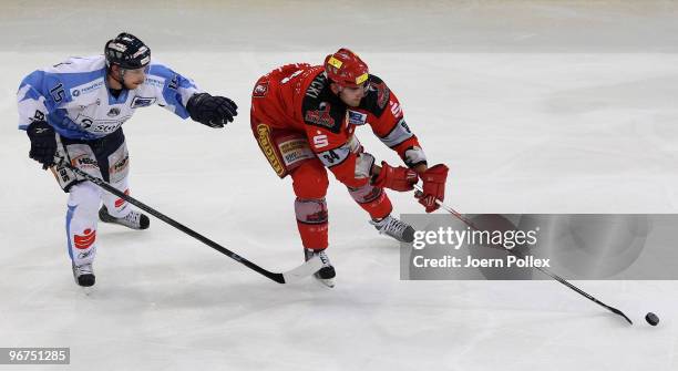 Matt Dzieduszycki of Hannover and Stephan Wilhelm of Straubing battle for the puck during the DEL match between Hannover Scorpions and Straubing...