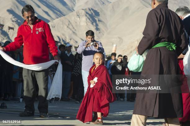 India, Ladakh, Leh, small monk honored at Shanti Stupa during tibetan ceremony.