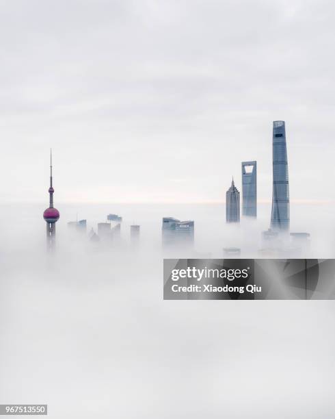 aerial view of shanghai lujiazui  in clouds - shanghai world financial center stock-fotos und bilder