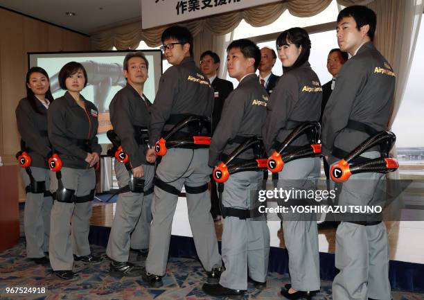 Airport Limousine bus service emloyees display robot suit Hybrid Assistive Limb , developed by Cyberdyne at the Haneda airport in Tokyo on November...