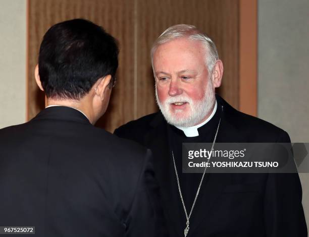 Most Reverend Archbishop Paul Gallagher of Vatican City State shakes is greeted by Japanese Foreign Minister Fumio Kishida for their talks at...