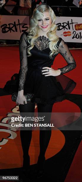 British singer Pixie Lott walks on the red carpet upon her arrival for The Brit Awards 2010 at Earls Court in London on February 16, 2010. Lott is up...