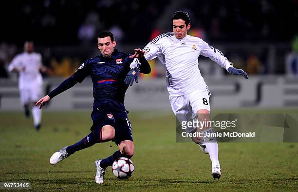 Kaka of Real Madrid is chellenged by Anthony Reveillere of Lyon during the UEFA Champions League round of 16 first leg match between Lyon and Real...
