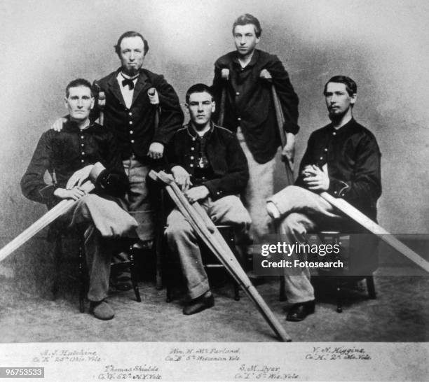 Portrait of five Union soldiers at the Armory Square Hospital, Washington DC, who have all lost limbs during the American Civil War: 'A.J. Hutchins,...