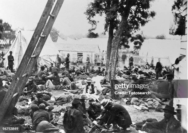 Union soldiers lay wounded awaiting treatment at a Union field hospital, at Savage Station, Virginia, USA, circa 1861. .