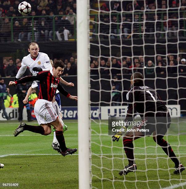 Wayne Rooney of Manchester United scores their second goal during the UEFA Champions League First Knock-Out Round match between AC Milan and...