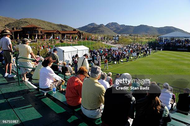 Fans watch players hit from the driving range during practice for the World Golf Championships-Accenture Match Play Championship at The Ritz-Carlton...