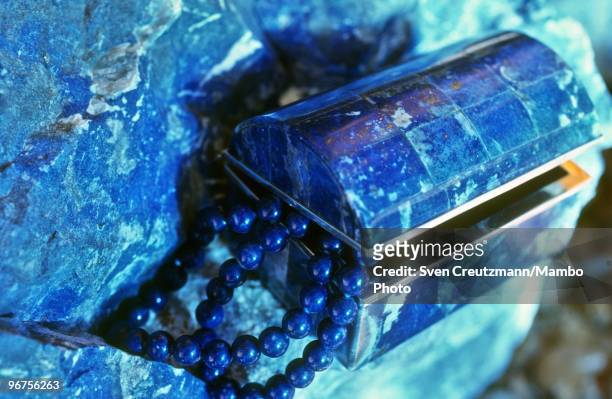 Chain and a jewellery box made of Lapis Lazuli lie on a raw Lapis Lazuli rock in the Flores de Los Andes mine, located at 3,700 meter high in the...