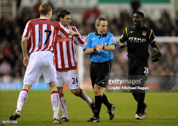 Rory Delap and Ryan Shawcross join Kolo Toure of Manchester City in speaking to referee Alan Wiley during the Barclays Premier League match between...
