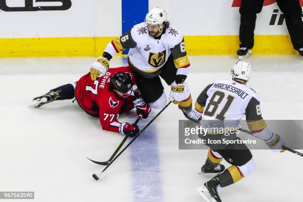Vegas Golden Knights defenseman Colin Miller tries to control puck as Washington Capitals right wing T.J. Oshie defends during game 4 of the 2018 NHL...