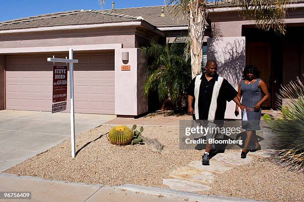 Prospective home buyer Robert Street, left, speaks with realtor Phyllis Jackson after looking at a home for sale in Chandler, Arizona, U.S., on...